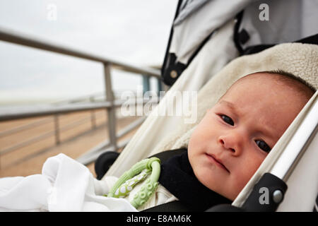 Baby boy in pushchair Stock Photo