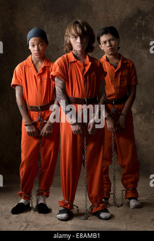 Boy in prisoner jumpsuit and handcuffs Stock Photo - Alamy