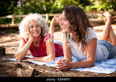 Mother and daughter on picnic blanket by the Blue Pool, Wareham, Dorset, United Kingdom Stock Photo