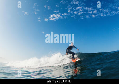 Mid adult man surfing wave, Leucadia, California, USA Stock Photo
