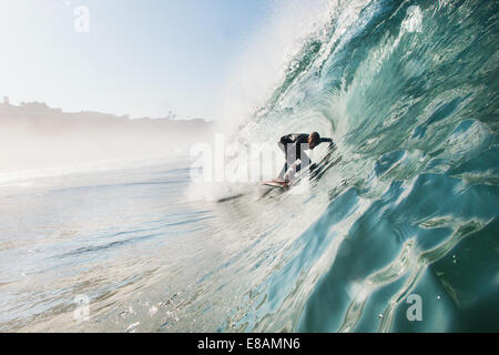 Mid adult man surfing rolling wave, Leucadia, California, USA Stock Photo