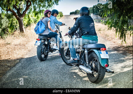 Three friends and one dog on motorcycles, Cagliari, Sardinia, Italy Stock Photo