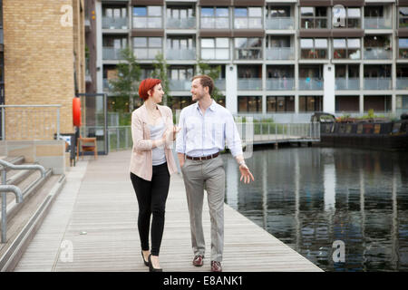 Couple walking along canal, East London, UK Stock Photo