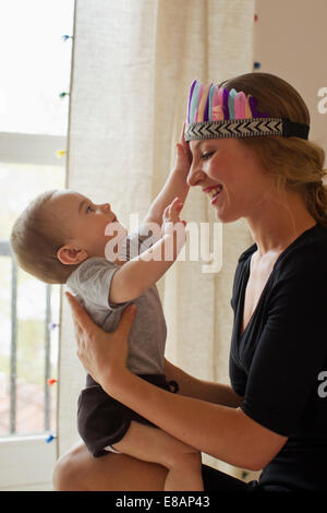 Mother playing with baby boy Stock Photo