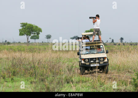 Group of photographers on a safari trip in Mikumi National Park in Tanzania. Stock Photo