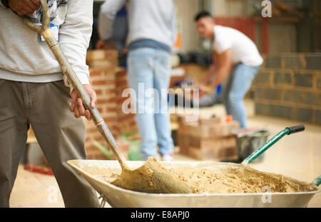 Cropped shot of three male college students in bricklaying workshop Stock Photo