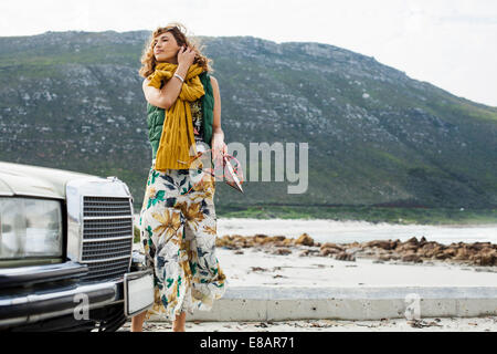 Young woman on breezy beach, Cape Town, Western Cape, South Africa Stock Photo