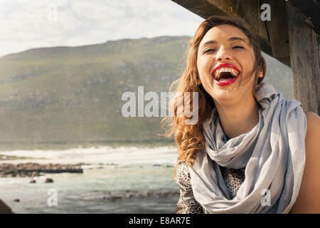 Young woman laughing on coastal pier, Cape Town, Western Cape, South Africa Stock Photo