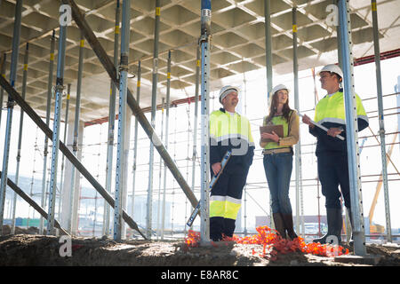 Site manager and architects chatting on construction site Stock Photo