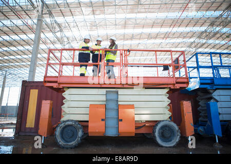 Low angle view of site managers and architect on viewing platform on construction site Stock Photo