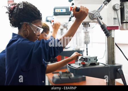 Students using drilling machines in college workshop
