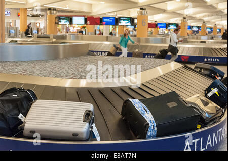 Baggage claim carousel and airline passengers at Hartsfield-Jackson Atlanta International Airport in Atlanta, Georgia, USA. Stock Photo