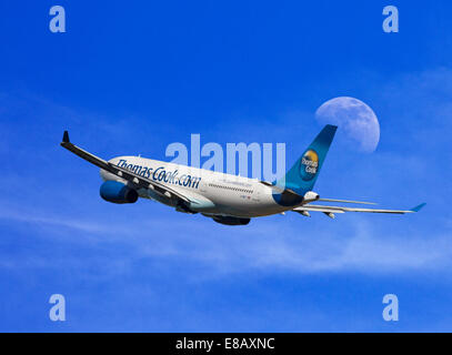 Thomas Cook Airbus A330-243 in flight against a daytime moon backdrop Stock Photo