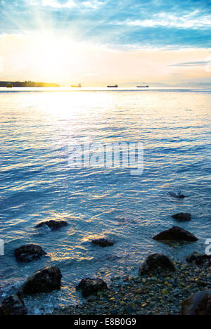 Sunset on the sea. Coastline and beautiful cloudscape. Stock Photo