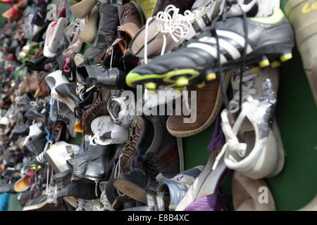 Collection of a Variety of Shoes Hanging on a Wall Stock Photo