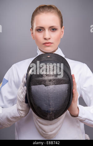 Young woman engaging in fencing Stock Photo