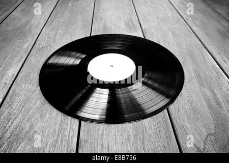 Vinyl record on wooden table black and white Stock Photo