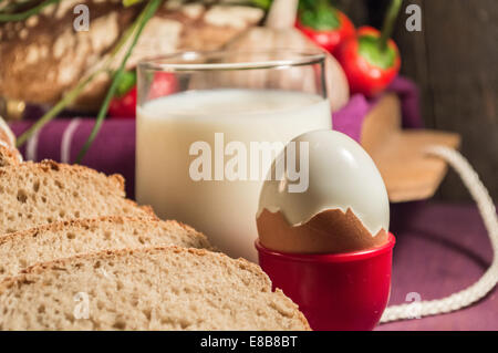 Bread, egg, milk and vegetables. Breakfast. Stock Photo