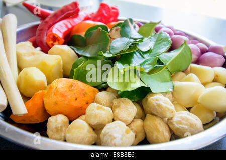 Fresh Ingredients for Cooking Southeast Asian Curry Dish Sauce with Chili Peppers Ginger Lemon Grass Onions Shallots Lime Leaves Stock Photo