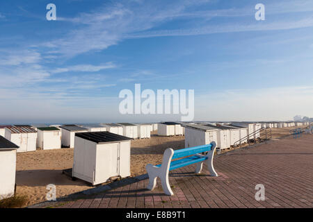 Blue bench and seafront huts on the beach, Calais, France Stock Photo