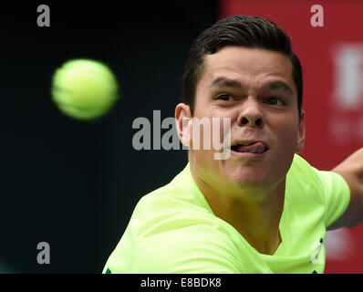 Tokyo, Japan. 4th Oct, 2014. Milos Raonic of Canada hits a return during the men's singles semifinal match against Gilles Simon of France at the Rakuten Japan Open Tennis Championships 2014 in Tokyo, Japan, Oct. 4, 2014. Credit:  Stringer/Xinhua/Alamy Live News Stock Photo
