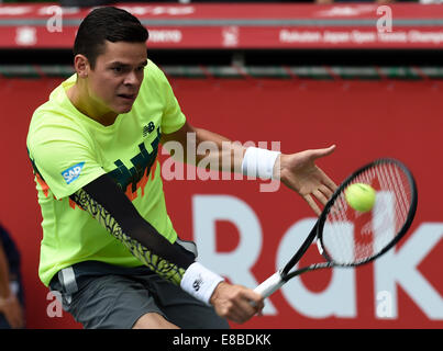 Tokyo, Japan. 4th Oct, 2014. Milos Raonic of Canada hits a return during the men's singles semifinal match against Gilles Simon of France at the Rakuten Japan Open Tennis Championships 2014 in Tokyo, Japan, Oct. 4, 2014. Credit:  Stringer/Xinhua/Alamy Live News Stock Photo