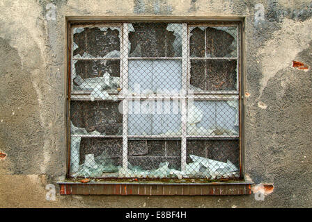 Broken window in an old industrial building Stock Photo
