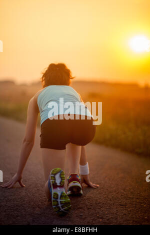 Sprinter start position on the track. Jogging sport Stock Photo