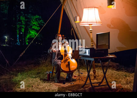 "Nightingales with Cello"  - by Jony Easterby and Kathy Hinde, part of 'For the Birds' - A 3km long two hour night-time trail of sound music and sculpture in celebration of birds at Ynys Hir nature reserve, near Aberystwyth Ceredigion Wales UK, 3 Oct 2014.   In 1924 Beatrice Harrison played cello with nightingales in her garden, live on BBC radio. Cellist NICK BARD here performs the same music with nightingales recorded during that time in her garden.  The 20 part installation continues tonight (4th) and tomorrow (5th) October   photo Credit: keith morris / Ģ����ý Live News Stock Photo