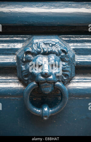 Old blue door knocker in shape of lion head Stock Photo