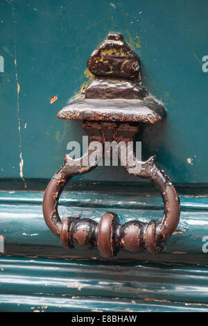 Old rusted knocker on green wooden door in Paris, France Stock Photo
