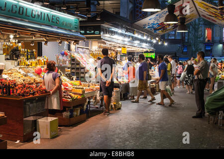 BARCELONA, SPAIN - AUGUST 25, 2014: buyers and sellers of La Boqueria, marketplace in old part of Barcelona Stock Photo