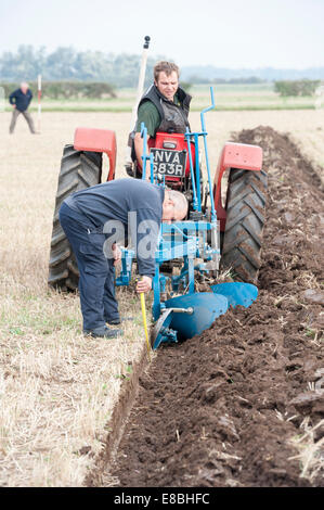 Cottenham, Cambridgeshire, UK. 4th October, 2014. Competitors take part in the Cottenham and District Ploughing Society match at Long Drove, Cottenham, Cambridgeshire, UK 4th October 2014.  Under big skies just north of Cambridge on the edge of the Fens, competitors aimed to keep straight lines and a precise finish in various categories including vintage and rotavators. Credit Julian Eales/Alamy Live News Stock Photo