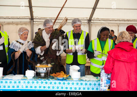 Nottingham, UK. 4th October, 2014. The Sheriff of Nottingham (Cllr Jackie Morris) and Robin Hood joined volunteers in serving free vegan curry at the feeding the 5,000 event in Nottingham. The aim was to serve 5,000 people with free curry made from food that would have been wasted. Feeding the 5,000 was started in London in 2009 to highlight the issues surrounding the way food is grown, farmed  and consumed in the U.K. in an attempt to find solutions to food wastage. Credit:  Mark Richardson/Alamy Live News Stock Photo