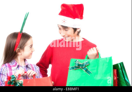 Young children happy with Christmas bags. Isolated on white. Christmas concept. Stock Photo