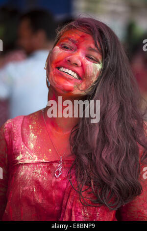 Dhaka, Bangladesh. 4th Oct, 2014. Bangladeshi Hindu devotees put vermillion and color on each other's faces as they dance on the final day of the Durga Puja Festival in Dhaka on October 4 2014. The five-day Durga Puja festival commemorates the slaying of a demon king Mahishasur by goddess Durga, marking the triumph of good over evil. Credit:  Zakir Hossain Chowdhury/ZUMA Wire/Alamy Live News Stock Photo