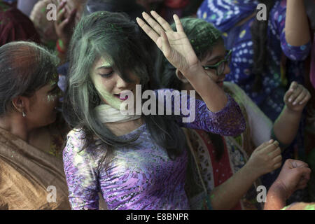 Dhaka, Bangladesh. 4th Oct, 2014. Bangladeshi Hindu devotees put vermillion and color on each other's faces as they dance on the final day of the Durga Puja Festival in Dhaka on October 4 2014. The five-day Durga Puja festival commemorates the slaying of a demon king Mahishasur by goddess Durga, marking the triumph of good over evil. Credit:  Zakir Hossain Chowdhury/ZUMA Wire/Alamy Live News Stock Photo