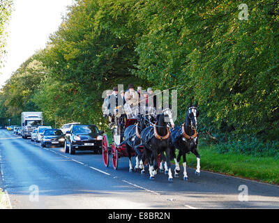 Stokenchurch, Buckinghamshire, UK. 4th October, 2014. This image shows a 19th Century horse-drawn stagecoach, the Tally Ho,driving through Stokenchurch in Buckinghamshire on its journey from The Feathers, Westminster, London on a 65 mile journey over two days to Oxford.  The Oxford Road was one of the great routes of the 19th Century and this journey aims to recreate the romance of that time while raising funds for The John Radcliffe Hospital in Oxford. Credit:  Glyn Fletcher/Alamy Live News Stock Photo