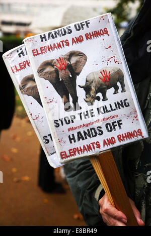 London, UK. 4th October 2014. Marchers with placards and banners at the Global March for Elephants and Rhinos, London, England. Rain didn't dampen the spirits of the marchers raising awareness of the plight of elephants and rhinos which amongst other things are being killed by poachers for ivory and souvenirs. Credit:  Paul Brown/Alamy Live News Stock Photo