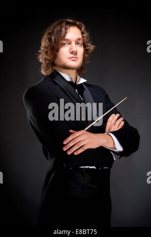 Portrait of a Young Conductor Holding a  Baton. Stock Photo