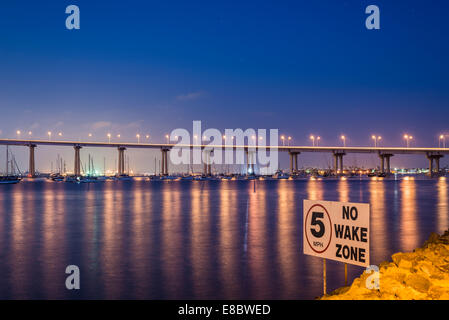 Lights of the Coronado Bridge reflecting off of San Diego Bay viewed at night. Coronado, California, United States. Stock Photo