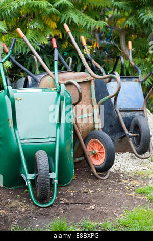 Stacked wheelbarrows in a garden