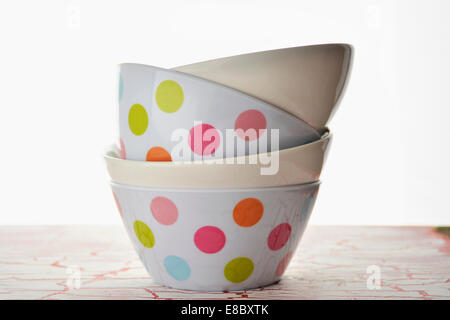 white bowls, with spots of color, stacked and empty Stock Photo