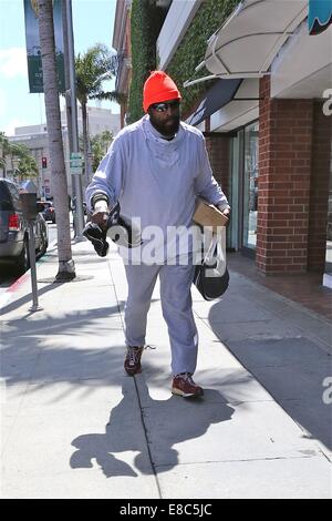 Mister T hands over a 'Mr T in your pocket' to a fan while out and about in Beverly Hills  Featuring: Mister T Where: Los Angeles, California, United States When: 01 Apr 2014 Stock Photo