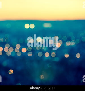 city blurring lights abstract circular bokeh on toned blue background with horizon, closeup Stock Photo