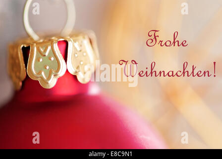 Red Christmas Ball Decoration with the German Words Frohe Weihnachten which means Merry Christmas Stock Photo