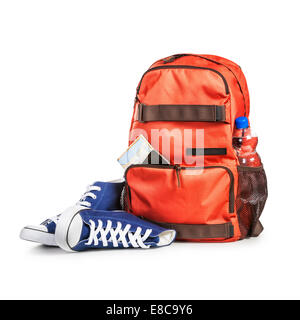 Backpack with bottle of water, smart phone, map and sport shoes isolated on white background. Tourism and travel themes. Clippin Stock Photo