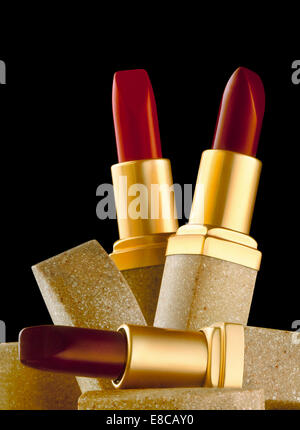 Three lipsticks in glamorous arrangement on black background.Clipping Path Stock Photo