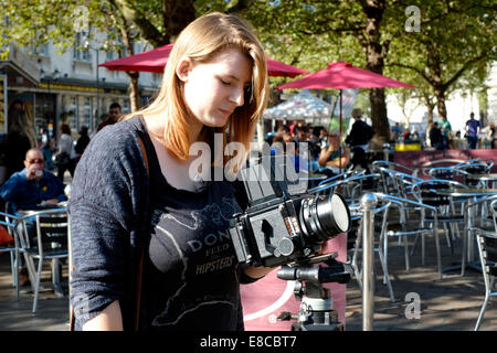 young female photography student learning to use a medium format roll film camera Stock Photo