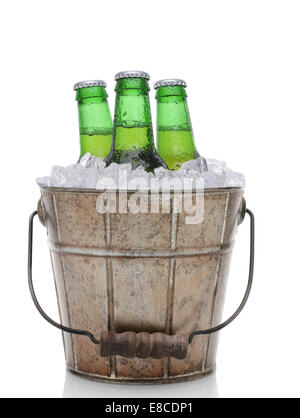 Closeup of an old fashioned beer bucket with three green bottles of cold beer. Isolated on white with reflection. Stock Photo